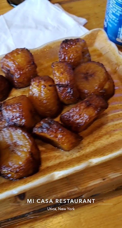 Plates of Caribbean food with bright garnishes.