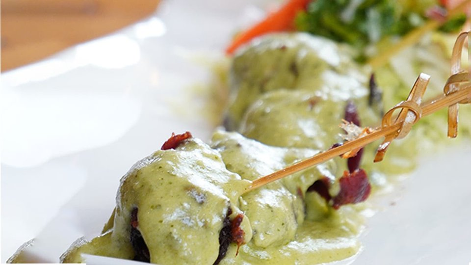 Dining table with vibrant plated entrées.